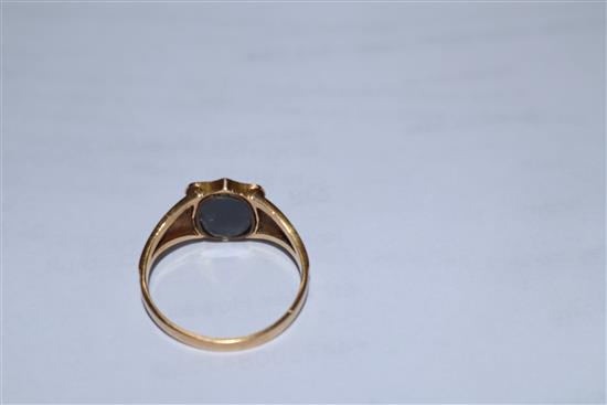 An early 19th century 18ct gold, black enamel and seed pearl set mourning ring,